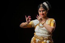 Mohiniattam Dancer Portraying The Character Of Lord Krishna Playing Flute

