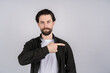 © Ivan - Young smiling man points with fingers in the right side