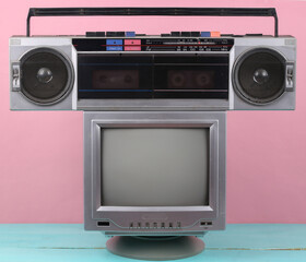 Wall Mural - 80s Retro outdated portable stereo radio cassette recorder, tv set on pink background. Attributes 80s, retro media, entertainment