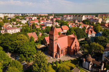 Canvas Print - Drone view of saint Adalbert's church between green trees in sunny day