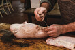 Hands making homemade head cheese, Patagonia, Argentina