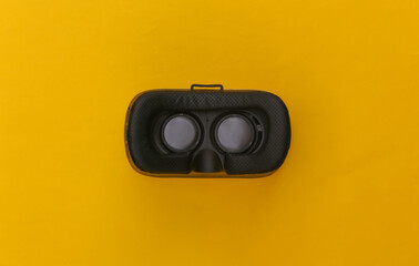 Wall Mural - Virtual reality headset on yellow background. Top view. Flay lay. Minimalism