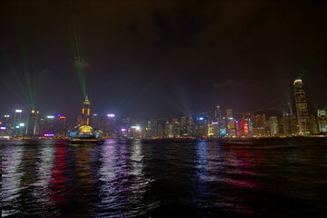 City landscape. Victoria Harbor and Hong Kong skyscrapers at night.