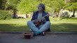 © nimito - Homeless musician playing guitar and singing begging for money on street