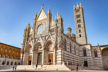 People walk in front of the dome of Siena near Florence