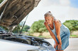 © JENOCHE - upset driver woman in front of automobile broken car collision accident at city road