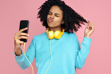 Cheerful African American Young Woman With Funny Face Take Picture With Smartphone Over Pink Background.