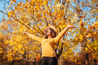 © maryviolet - Fall season activities. Woman throwing leaves in autumn park. Young girl having fun outdoors