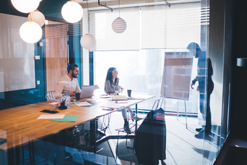 Coworkers discussing project in modern design office