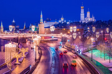 Wall Mural - Moscow. Russia. Kremlin embankment on a winter evening. Moscow view from the drone. Cars ride on a winter road. New Year Kremlin Christmas decorations on lanterns and trees. Guide to Russia