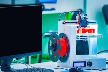 3D printer. Creating three-dimensional objects. The printer prints the object layer by layer. The printer is connected to the computer. New printing technologies. Modern technology.
