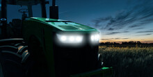 Agricultural Tractor With Headlights At Night