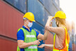 © JU.STOCKER - Factory worker man checking fever by digital thermometer for scan and protect from Coronavirus (COVID-19) at cargo containers - Healthcare Concept