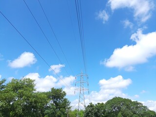 Wall Mural - Electricity Tower. High voltage post or High voltage tower. View of  fields with high-voltage transmission lines and electricity Towers. high voltage post. High-voltage tower sky background.