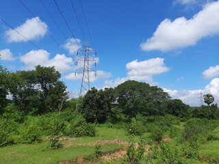 Wall Mural - Electricity Tower. High voltage post or High voltage tower. View of  fields with high-voltage transmission lines and electricity Towers. high voltage post. High-voltage tower sky background.