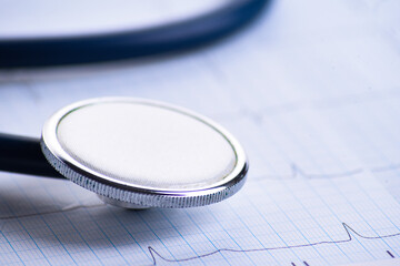 Cardiogram with stethoscope on table, closeup