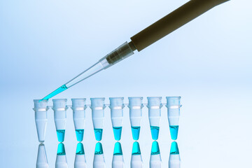 Poster -  PCR Tube Strips Well  and Pipette in genetic research laboratory close up