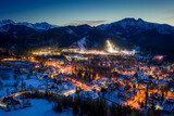 Fototapeta  - Stunning illuminated Zakopane city at night in winter, drone view