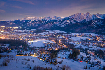 Wall Mural - Illuminated Zakopane city in winter at night, view from above