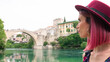 © Natasa - Portrait of a woman looking at the Old Bridge in Mostar city, Bosnia and Herzegovina.