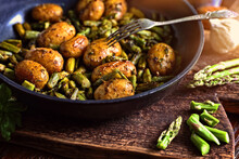 Asparagus With Potatoes Fried In A Pan With Herbs