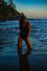 Wall Mural - woman in a bikini posing on the beach