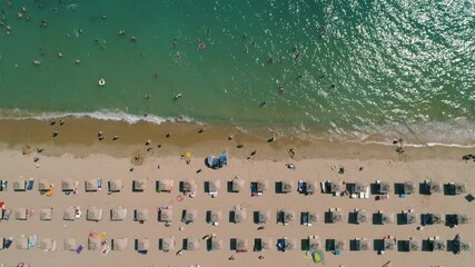 Wall Mural - Aerial top view of sea, beach, sand, umbrellas and happy people. Summer seascape.