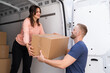 © Andrey Popov - Couple Moving Boxes From Van Or Truck