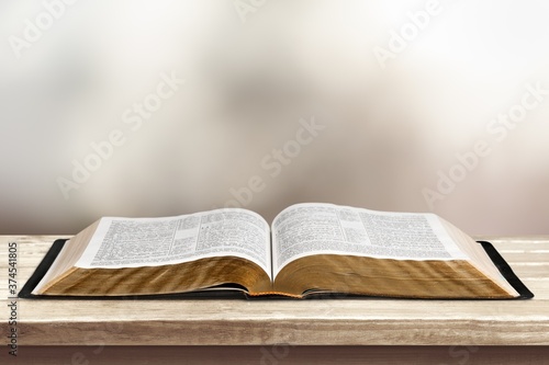 Open vintage christian bible on desk
