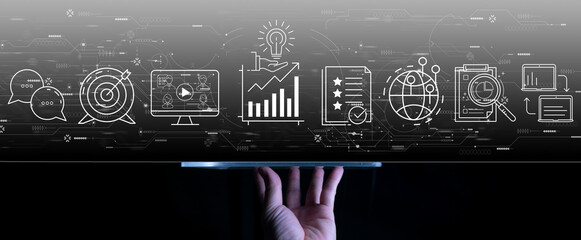 content marketing concept with woman hand using a digital tablet computer on dark grey backgroiund.