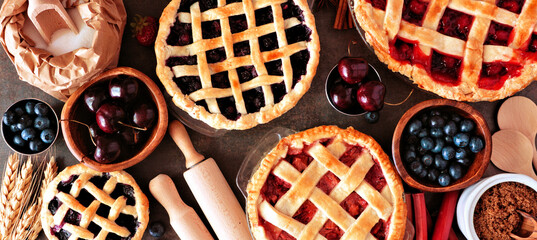 Aufkleber - Baking scene with a variety of homemade fruit pies. Top view over a wood banner background.