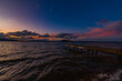 © Ingmar - silhouette of a woman on a pier at the beach at sunset