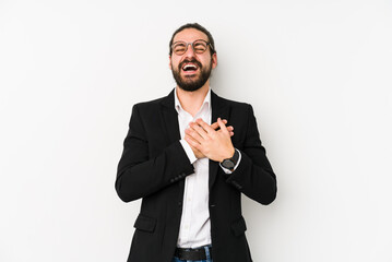 Wall Mural - Young caucasian business man isolated on a white background laughing keeping hands on heart, concept of happiness.