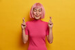 © wayhome.studio  - Wishful positive Asian woman crosses fingers before important event smiles happily stands with eyes shut has big hope in better, trendy bob hairstyle, isolated on yellow studio wall, wishes fortune