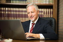 Businessman Using His Laptop In A Library