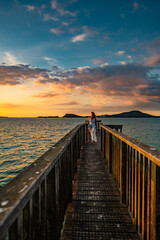 Wall Mural - woman on a pier at sunset