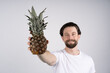 © Ivan - Man with long beard holds pineapple in hands. Dieting and fitness. Look at camera