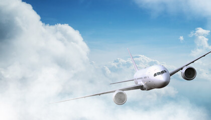 Wall Mural - Commercial airplane jetliner flying above dramatic clouds in beautiful light. Travel concept.