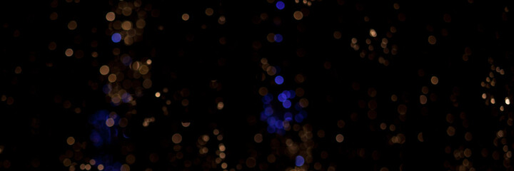sparse background with golden and blue bokeh on black