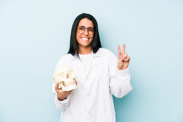 Doctor caucasian woman isolated on blue background showing number two with fingers.