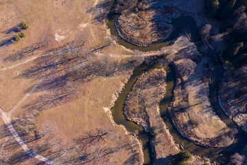 Wall Mural - Drone shot flying on spring river in forest