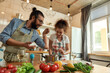 © Svitlana - Italian man adding pepper, spice to the soup while woman stirring it and smiling. Couple preparing a meal together in the kitchen. Cooking at home, Italian cuisine