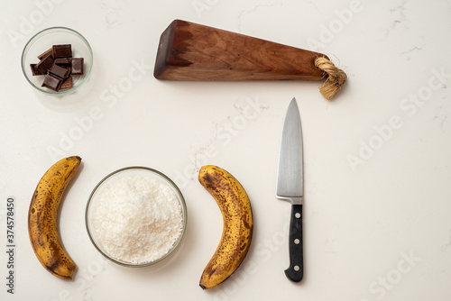 Photographie Coconut and banana cookies preparation drizzled with melted chocolate