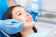 © Elena - dentist examines the patients teeth at the dentist.