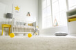 Cute baby room interior with crib and big window, low angle view