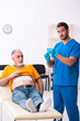 © Elnur - Old man visiting young male doctor