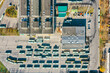 buses parked in rows at bus depot near garage buildings. aerial top view of industrial district. 