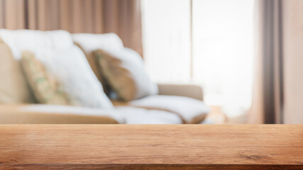 Empty wood table top and blurred living room in home interior with curtain window background. - can used for display or montage your products.