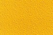 © torsakarin - Rough cement wall painted yellow texture and seamless background , Concrete wall texture and background
