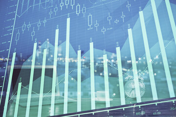 Stock market graph and table with computer background. Double exposure. Concept of financial analysis.